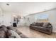 Inviting living room with a large window, cozy couches, and modern flooring at 4871 S Dunkirk Way, Centennial, CO 80015
