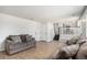 Comfortable living room with modern flooring, light walls, and easy access to kitchen at 4871 S Dunkirk Way, Centennial, CO 80015