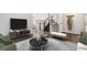 Staged living room showcasing wood floors, neutral decor, and open floorplan for entertaining at 4871 S Dunkirk Way, Centennial, CO 80015