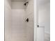 Modern shower with light tile and fixtures at 4871 S Dunkirk Way, Centennial, CO 80015