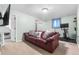 Comfortable basement Gathering room with neutral carpet and a red leather couch at 10450 Iris Way, Broomfield, CO 80021