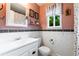 Bright bathroom features white subway tile, decorative border, and stylish fixtures at 10450 Iris Way, Broomfield, CO 80021