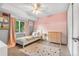 Charming bedroom with bright window, carpet, and a playful striped accent wall at 10450 Iris Way, Broomfield, CO 80021