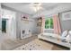 Comfortable bedroom with a colorful rug, bright window and whimsical decorations at 10450 Iris Way, Broomfield, CO 80021