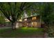 Traditional two-story home with brick and wood siding, a well-manicured lawn, and mature trees at 10450 Iris Way, Broomfield, CO 80021