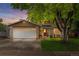 Charming two-story home featuring a brick and wood facade, mature tree, and a two-car garage at 10450 Iris Way, Broomfield, CO 80021