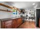 Updated kitchen with cherry cabinets, floating shelves and updated appliances at 10450 Iris Way, Broomfield, CO 80021
