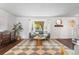 Bright living room featuring a bay window, hardwood floors, and neutral decor at 10450 Iris Way, Broomfield, CO 80021