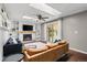 Bright living room with skylights, fireplace, built-ins and sliding glass door to backyard at 10450 Iris Way, Broomfield, CO 80021