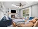 Cozy living room with fireplace, skylights, and sliding glass door at 10450 Iris Way, Broomfield, CO 80021