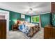 Spacious bedroom with ample natural light, ceiling fan, and adjacent bathroom at 10450 Iris Way, Broomfield, CO 80021
