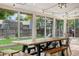 Bright sunroom with large windows, backyard view, and dining table at 10450 Iris Way, Broomfield, CO 80021