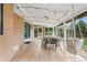 Enclosed sunroom featuring tile flooring, dining area, and backyard access at 10450 Iris Way, Broomfield, CO 80021