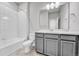 Bathroom showcases a tub, toilet, and vanity with ample lighting for a comfortable experience at 8911 Eagle River St, Littleton, CO 80125