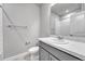 Bathroom features a sink, toilet, and a shower with white tiles at 8911 Eagle River St, Littleton, CO 80125