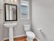 Cozy half bathroom features modern fixtures and a pedestal sink at 8911 Eagle River St, Littleton, CO 80125