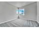 Well-lit bedroom with neutral walls, carpet, and a window providing scenic views at 8911 Eagle River St, Littleton, CO 80125