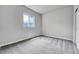 Serene bedroom with large window and neutral carpet, offering a tranquil retreat at 8911 Eagle River St, Littleton, CO 80125