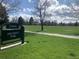 Sign for Ash Grove Park near green sports fields offering outdoor recreational activities for families at 4855 E Atlantic Pl, Denver, CO 80222