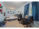 A bright bedroom featuring blue walls, a single bed, a window and posters of sport figures and sailing at 4855 E Atlantic Pl, Denver, CO 80222