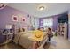 A purple bedroom featuring a bed with a white metal frame, a window, and a light with a purple shade at 4855 E Atlantic Pl, Denver, CO 80222
