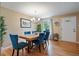 Cozy dining room featuring hardwood floors, a chandelier, and comfortable seating for six at 4855 E Atlantic Pl, Denver, CO 80222