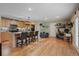 Open concept kitchen with island seating and modern appliances flows into a living and office space at 4855 E Atlantic Pl, Denver, CO 80222