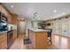 Well-appointed kitchen with wood cabinets, stainless steel appliances, and an island with bar seating at 4855 E Atlantic Pl, Denver, CO 80222
