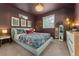Cozy bedroom featuring a comfortable bed with decorative pillows and stylish accents at 18552 E 54Th Ave, Denver, CO 80249