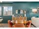 Well-lit dining area with a wooden table set and decorative buffet at 18552 E 54Th Ave, Denver, CO 80249