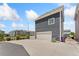 Detached garage with spacious driveway, low maintenance landscaping, and modern gray siding at 18552 E 54Th Ave, Denver, CO 80249