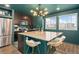 Stylish kitchen with modern stainless steel appliances, an island, and a unique light fixture at 18552 E 54Th Ave, Denver, CO 80249