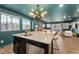 Modern kitchen island with granite countertops and adjacent living and dining areas at 18552 E 54Th Ave, Denver, CO 80249
