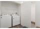 Functional laundry room with washer, dryer, and ample storage space at 18552 E 54Th Ave, Denver, CO 80249