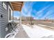Charming patio area with seating, offering a cozy outdoor space and curb appeal at 18552 E 54Th Ave, Denver, CO 80249