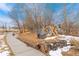 Natural playground with wooden structures and soft landing surfaces, nestled among the trees at 18552 E 54Th Ave, Denver, CO 80249