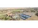 Aerial view of community clubhouse with pool, tennis courts, and distant neighborhood homes at 26781 E Clifton Dr, Aurora, CO 80016