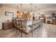Spacious wet bar with tile floors, granite counters, raised seating, and beautiful cabinetry at 26781 E Clifton Dr, Aurora, CO 80016