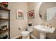 Powder bathroom with unique décor, a pedestal sink, and wood floors at 26781 E Clifton Dr, Aurora, CO 80016