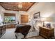Well-lit bedroom featuring a window seat, wood ceiling, and ensuite bathroom at 26781 E Clifton Dr, Aurora, CO 80016