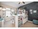 Bright craft room features a storage unit, sewing machine, work table, and a wall of supplies at 26781 E Clifton Dr, Aurora, CO 80016