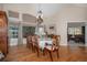 Formal dining room featuring hardwood floors, wainscoting and an elegant chandelier above the dining table at 26781 E Clifton Dr, Aurora, CO 80016