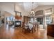 Elegant dining room featuring a fireplace, chandelier, and large windows showcasing natural light at 26781 E Clifton Dr, Aurora, CO 80016
