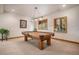 Finished game room with a pool table, stylish lighting, and neutral carpeting at 26781 E Clifton Dr, Aurora, CO 80016