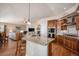 Open-concept kitchen with granite countertops, stainless steel appliances, and hardwood floors at 26781 E Clifton Dr, Aurora, CO 80016