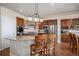 Open kitchen with island seating, stainless steel appliances, and custom cabinetry at 26781 E Clifton Dr, Aurora, CO 80016