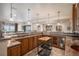 Open kitchen with wooden cabinets, granite counters, tile backsplash, and bar seating at 26781 E Clifton Dr, Aurora, CO 80016