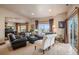 Bright living room with black leather couches, large window, neutral colors, and elegant decor at 26781 E Clifton Dr, Aurora, CO 80016