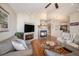 Inviting living area with fireplace, hardwood floors, and cozy couches at 26781 E Clifton Dr, Aurora, CO 80016