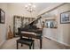 Living Room features a piano, chandelier, and glass display cabinets at 26781 E Clifton Dr, Aurora, CO 80016